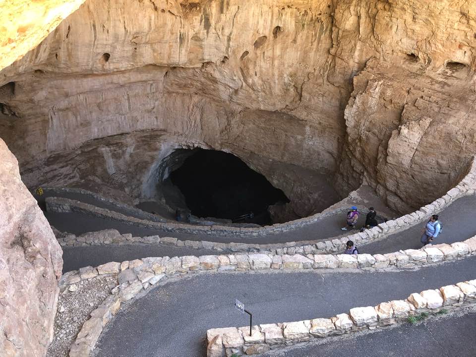 A view from the entrance into Carlsbad Caverns. It is a winding stone path that goes down into the cave.