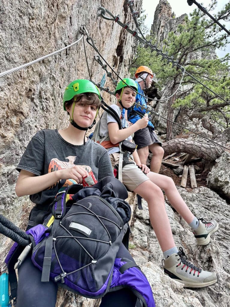 Group of hikers resting during their climb of the Via Ferrata
