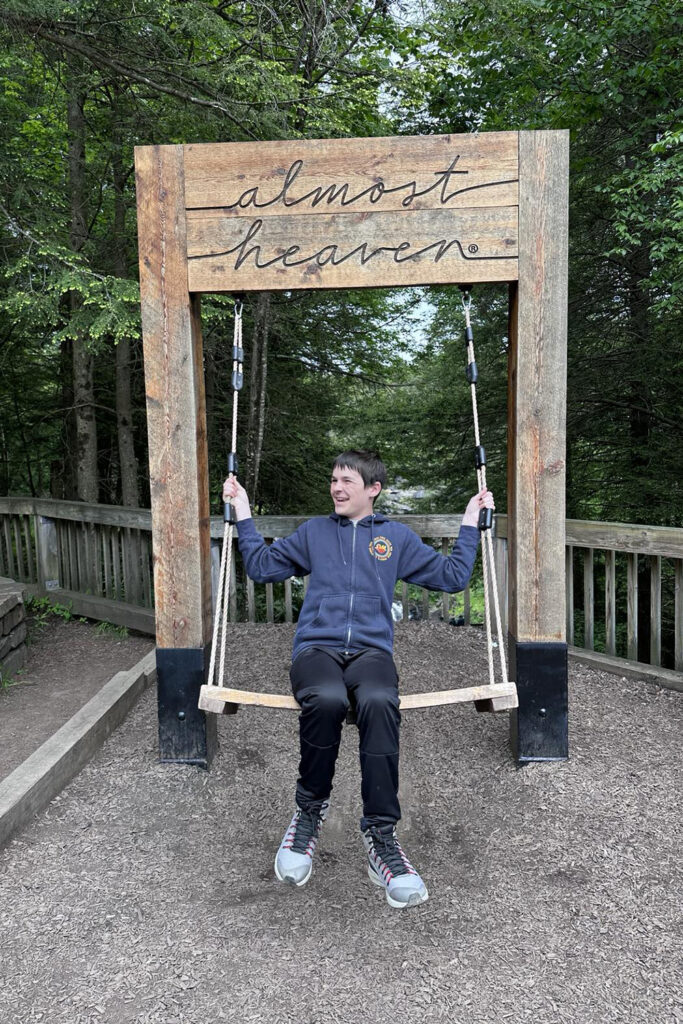 Kid swinging on the almost heaven swing at Blackwater Falls